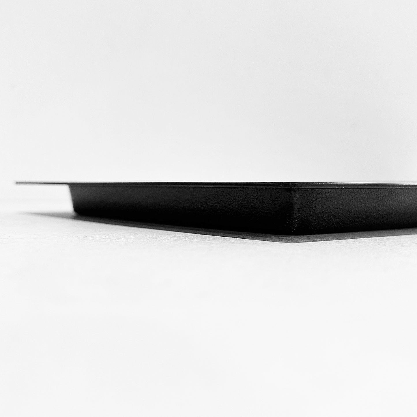 Side view of outward mounted foundation vent cover (black)