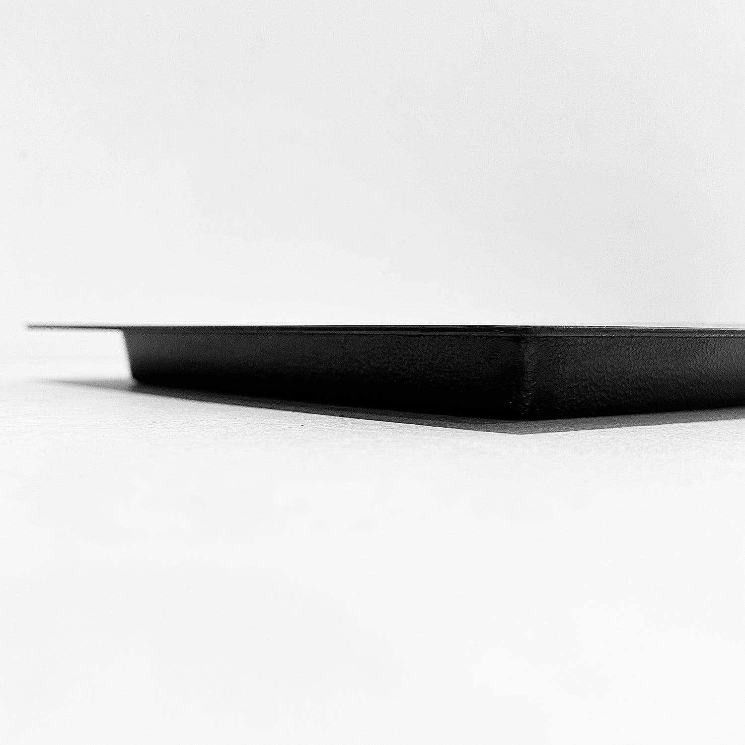 Side view of outward mounted foundation vent cover (black)