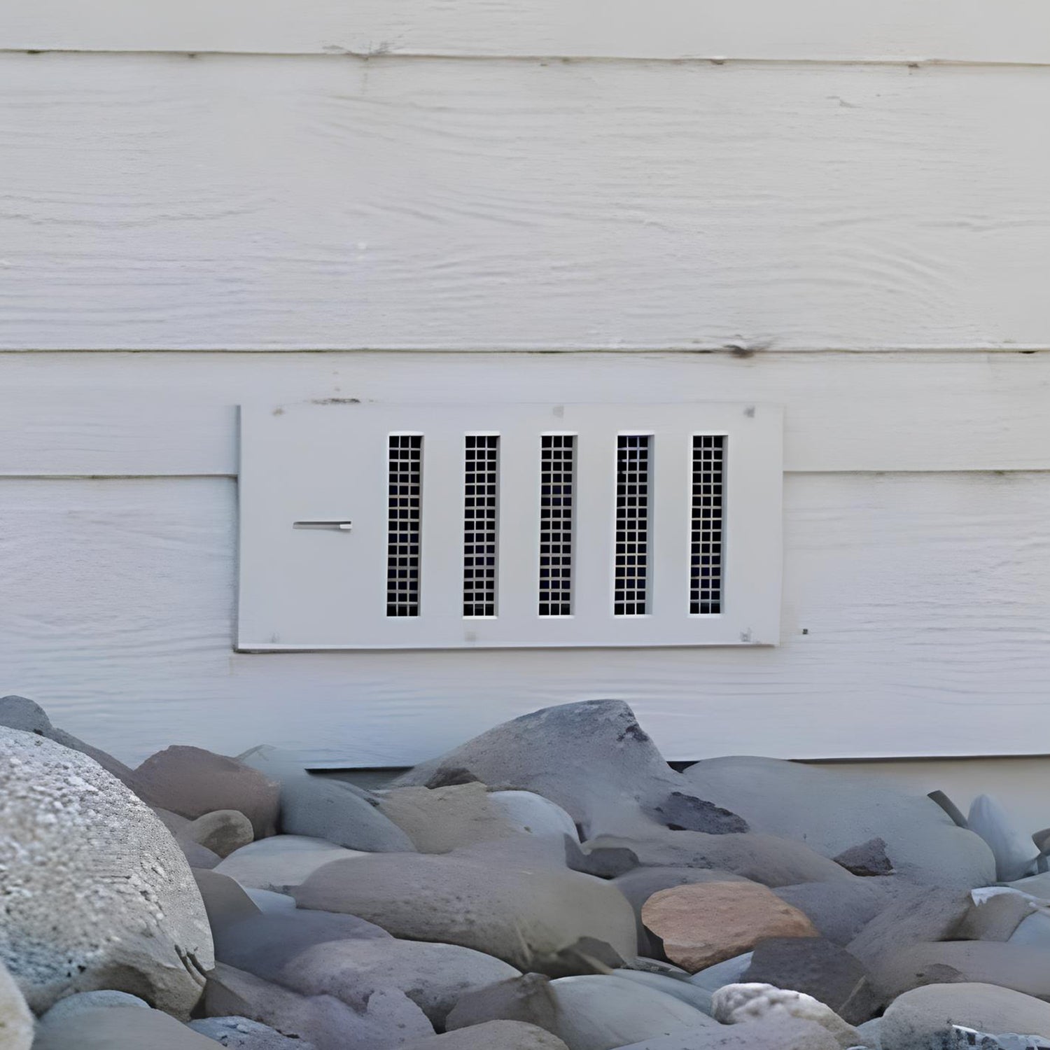 Foundation vent installed on side of home