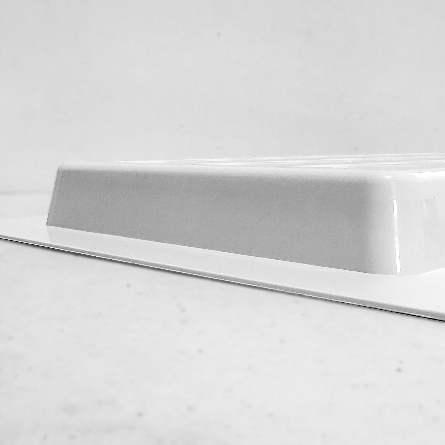 Side view of white recessed air vent cover