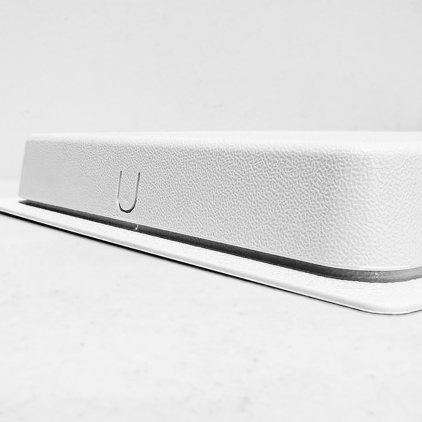 Side view of white air vent with cover
